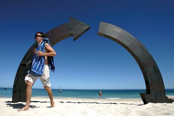 A swimmer walks past "Roundabout" a sculpture by Jennifer Cochrane of Western Australia A swimmer walks past "Roundabout" a sculpture by Jennifer Cochrane of Western Australia to illustrate Losses on the home front proving costly for Australian universities