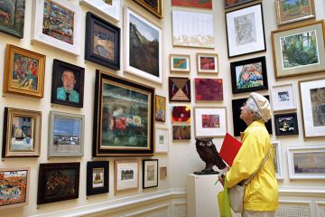 Woman looks at art in gallery