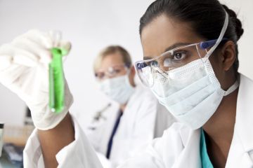 An Asian scientist holding a test tube