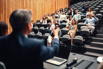 A speaker nominates people in the audience to ask questions A speaker nominates people in the audience to ask questions