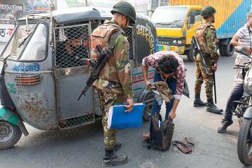 A police inspection in Dhaka, illustrating quality control A police inspection in Dhaka, illustrating quality control