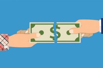 A dollar bill being torn A dollar bill being torn