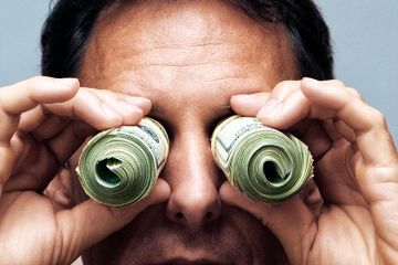 Man searching using money as binoculars. To illustrate whether journals that pay peer reviewers can succeed.