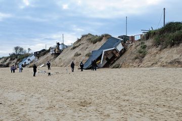 Houses collapsed by a beach Houses collapsed by a beach