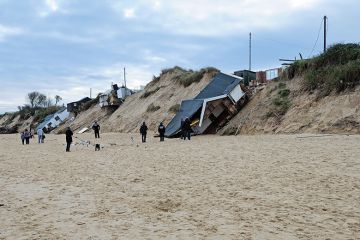 Houses collapsed by a beach