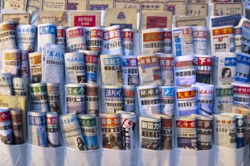 Beijing, China - March 12, 2012 Chinese newspapers in a newsstand