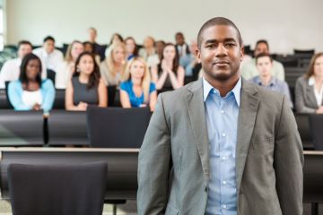 A black academic in a lecture hall A black academic in a lecture hall
