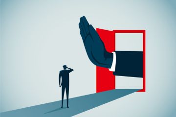 A hand blocks a door, symbolising restricted university access