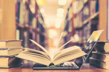 Book and laptop in library