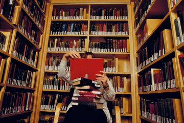 Person reading books in library Person reading books in library