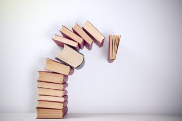 Pile of books falling over