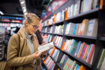 woman reading in a bookshop woman reading in a bookshop