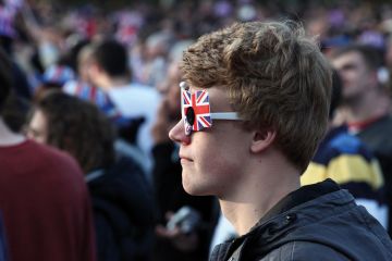 Boy wears Union Jack glasses Boy wearing Union Jack glasses