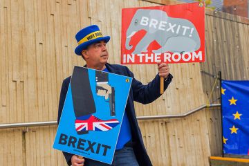 Steve Bray, famous brexit campaigner, holds up signs Brexit Elephant in the room and Brexit shooting self in foot as various different groups held demonstrations outside the ACC conference centre, 22 September, 2024.