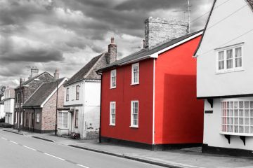 Bright red house on washed-out British street Bright red house on washed-out British street