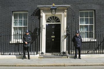 British police officers guarding 10 Downing Street entrance, London