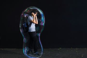 Young man inside giant bubble