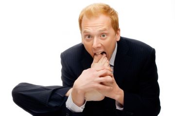 Businessman with foot in mouth