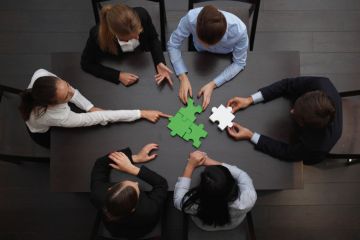 Businesspeople discussing how to reconnect Businesspeople discussing how to reconnect