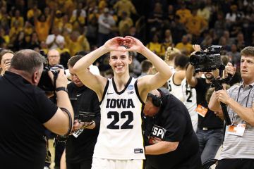 Caitlin Clark gestures to the crowd Caitlin Clark #22 of the Iowa Hawkeyes gestures to the crowd as she leaves the court after the game against the West Virginia Mountaineers during their second round match-up in the 2024 NCAA Division 1 Women's Basketball Championship