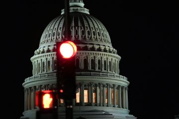The US capitol building with a red traffic light in front of it, illustrating democracy under threat The US capitol building with a red traffic light in front of it, illustrating democracy under threat