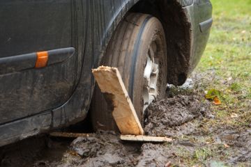 A car wheel stuck in a rut