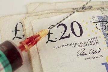 istock cash injection a syringe with a £20 note