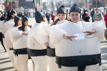 Women dressed in inflatable sumo-wrestler costumes Women dressed in inflatable sumo-wrestler costumes to illustrate Universities ‘partly to blame’ for Chinese graduates’ job woes
