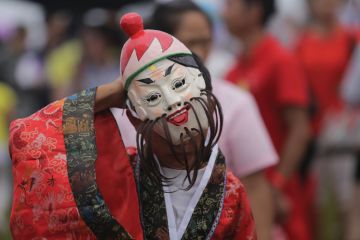 Chinese folk artist wearing mask performs Chinese folk artist wearing mask performs