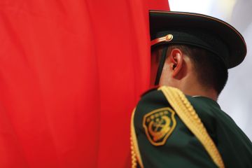 Chinese soldier with face in flag of China, Beijing, 2015 Chinese soldier with face in flag of China, Beijing, 2015