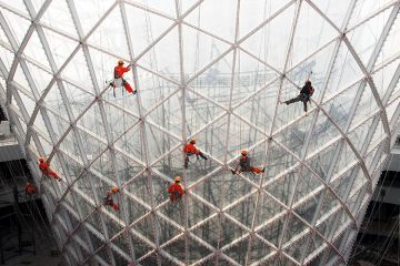Workers clean the exterior of the Sun Valley pavilion in Shanghai, China Workers clean the exterior of the Sun Valley pavilion in Shanghai, China