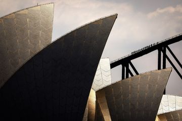 People climb the Sydney Harbour Bridge behind the Sydney Opera House, illustrating the soaring costs of educating Australian university students People climb the Sydney Harbour Bridge behind the Sydney Opera House, illustrating the soaring costs of educating Australian university students