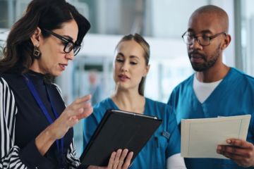 Medical scientists discuss results, illustrating clinical trials