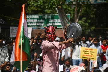 A supporter of the Cockroach Janta Party bangs a plate during a sit-in protest demanding the resignation of Indian education minister Dharmendra Pradhan in New Delhi in June A supporter of the Cockroach Janta Party bangs a plate during a sit-in protest demanding the resignation of Indian education minister Dharmendra Pradhan in New Delhi in June