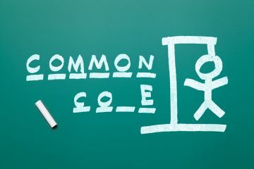 A blackboard with "common core" written on it