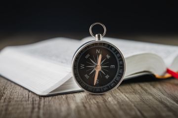 A compass and a book