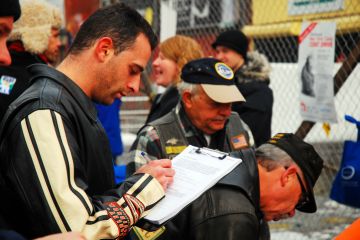 Coney Island, NY, USA January 1,An adult man signs a waiver before participating in the Polar Bear ocean swim on New Years day in Coney Island, New York