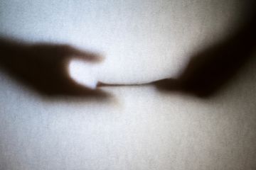 blurred outline of hands Corruption