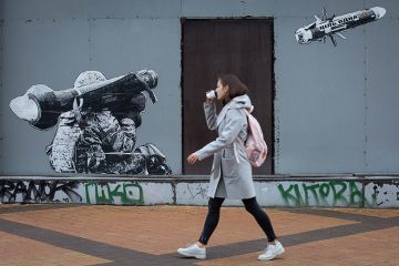 A woman passes by graffiti depicting a Ukrainian serviceman making a shot with a US-made Javelin portable anti-tank missile system in central Kyiv A woman passes by graffiti depicting a Ukrainian serviceman making a shot with a US-made Javelin portable anti-tank missile system in central Kyiv