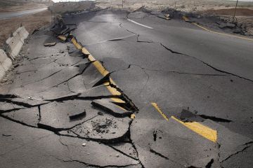 Cracked road damaged by earthquake Cracked road damaged by earthquake
