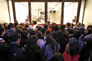 Shoppers wait outside Selfridges as the store opens it doors on the first day of its winter sale on Boxing Day. To illustrate that some universities are enrolling hundreds of research students despite warnings.
