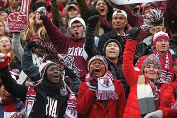 Crowd of Harvard University students cheering American football game