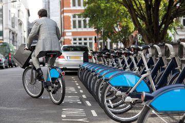 Man in suit rides Boris bike (Santander cycle) in London Man in suit rides Boris bike (Santander cycle) in London