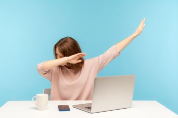 A woman watching a computer and doing a dab dance, symbolising online learning