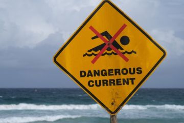 A sign in Australia reading "dangerous currents" A sign in Australia reading "dangerous currents"
