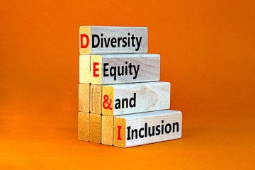 A pile of wooden bricks spelling out DEI A pile of wooden bricks spelling out DEI