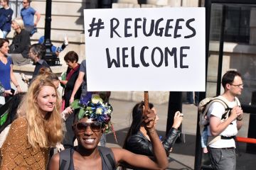 Demonstrator holding 'Refugees welcome' placard, London, England Demonstrator holding 'Refugees welcome' placard, London, England