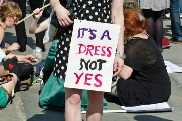 Demonstrator wearing 'It's a dress, not yes' placard Demonstrator wearing 'It's a dress, not yes' placard