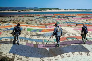 Montage of metal detectorists on beach with newsprint. To illustrate the scramble to create AI essay detectors.