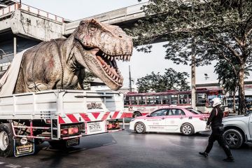 A huge plastic dinosaur in the back of a lorry A huge plastic dinosaur in the back of a lorry
